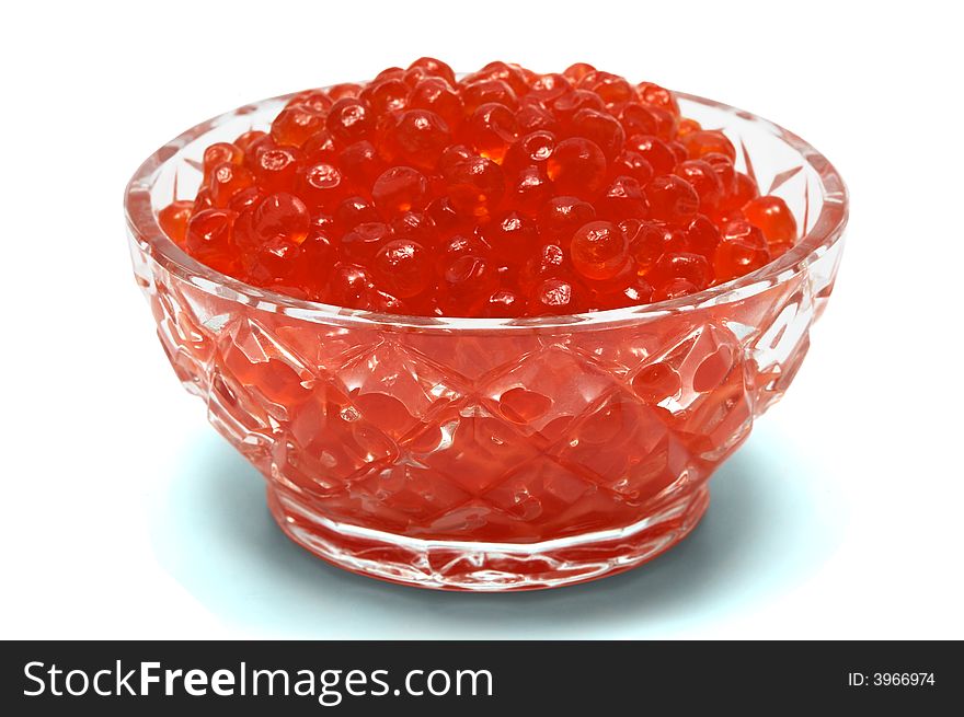 Crystal dish with red caviar on a white background