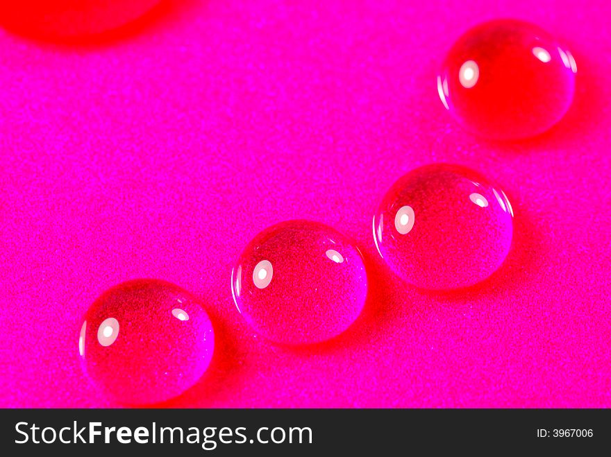Close up shoot of pink colored water drops. Close up shoot of pink colored water drops