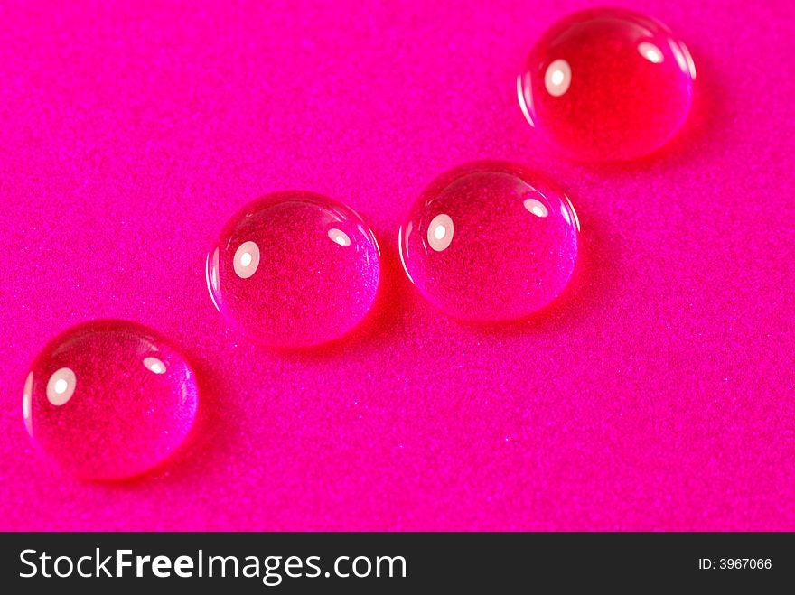 Close up shoot of pink colored water drops. Close up shoot of pink colored water drops