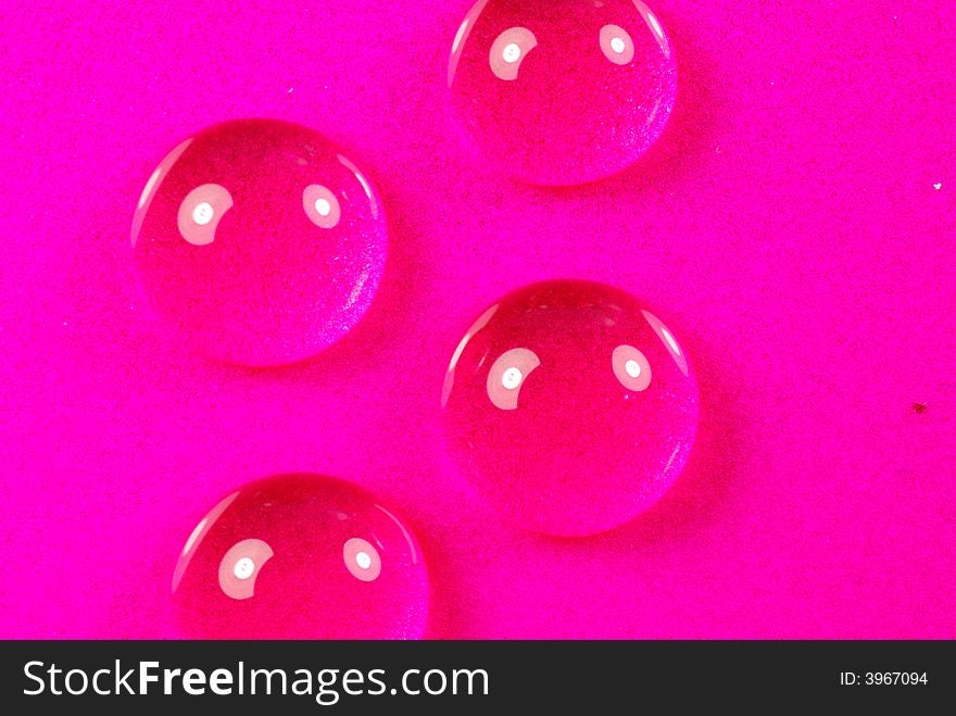 Close up shoot of pink colored water drops. Close up shoot of pink colored water drops