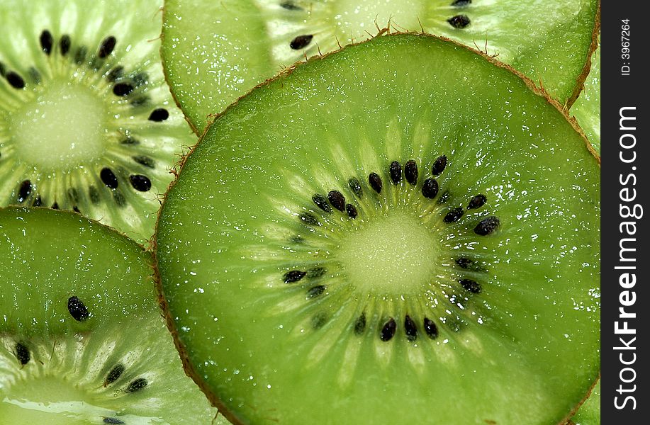 Few pieces of kiwi fruit like a background
