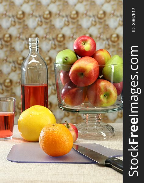 A table set with fresh apples and oranges