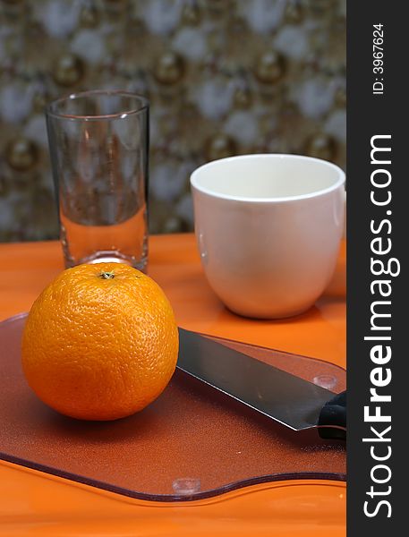 Breakfast table set with coffee and an orange. Breakfast table set with coffee and an orange