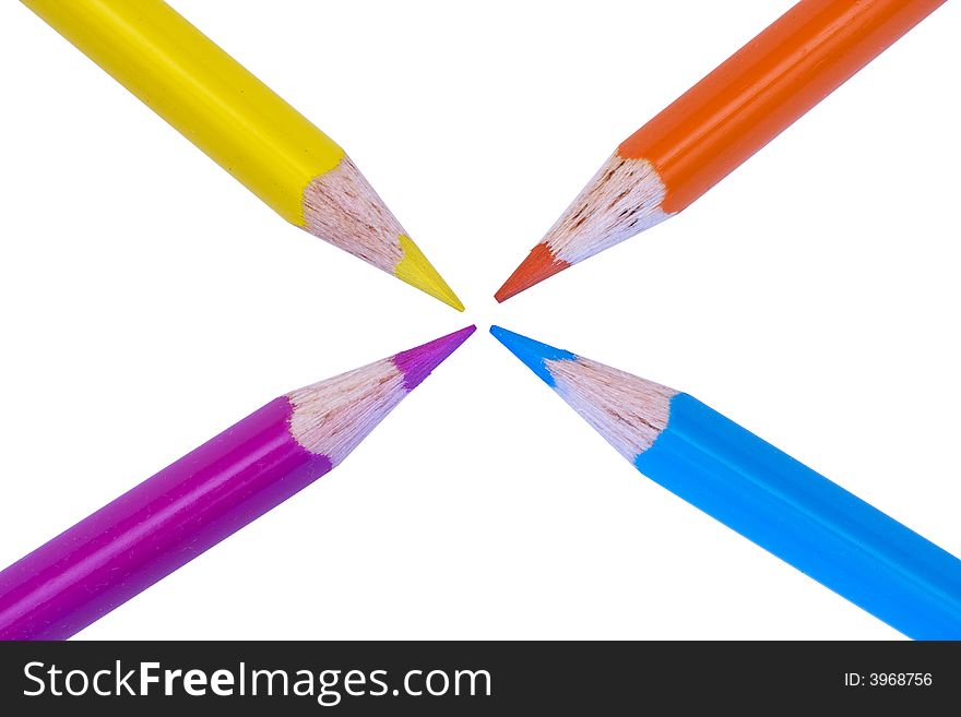 4 colored pencils all pointing to center of page on white background. 4 colored pencils all pointing to center of page on white background