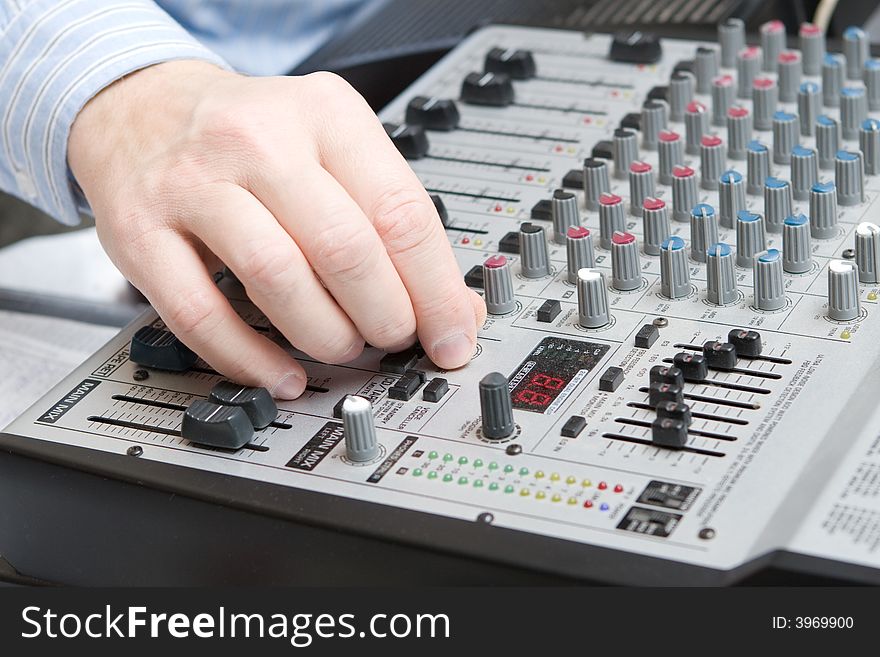 Hand adjusts setting on the board of a synthesizer. Hand adjusts setting on the board of a synthesizer