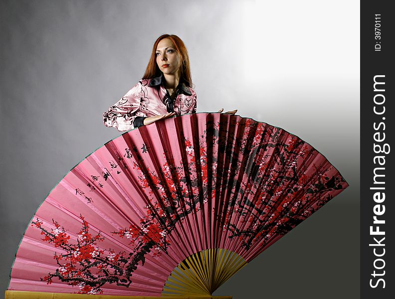 Beautiful girl with japanese pink fan. Beautiful girl with japanese pink fan