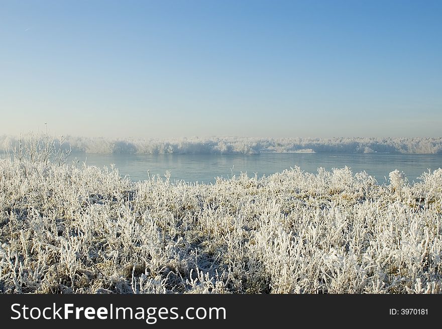 Winter lake with snow and blue sky. Winter lake with snow and blue sky