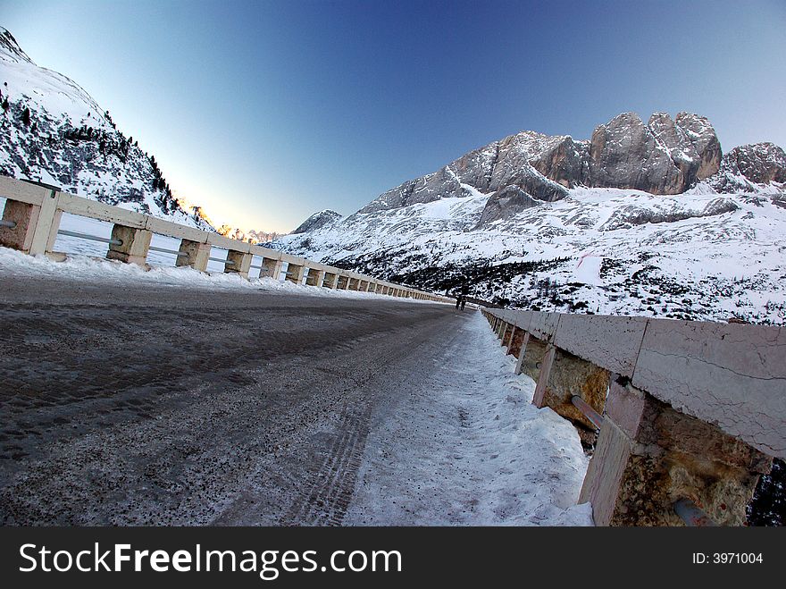 Iced road  between lake and Mountains (Marmolada - North Italy). Iced road  between lake and Mountains (Marmolada - North Italy)