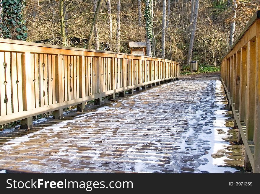 Wooden bridge in a park the frozen with snow. Wooden bridge in a park the frozen with snow.