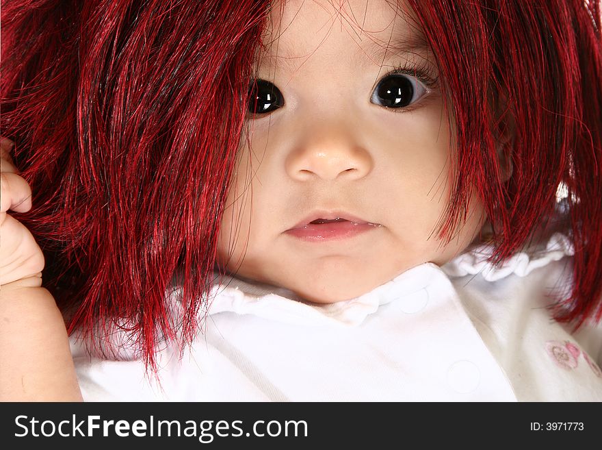 Baby girl in red shag wig. Baby girl in red shag wig.