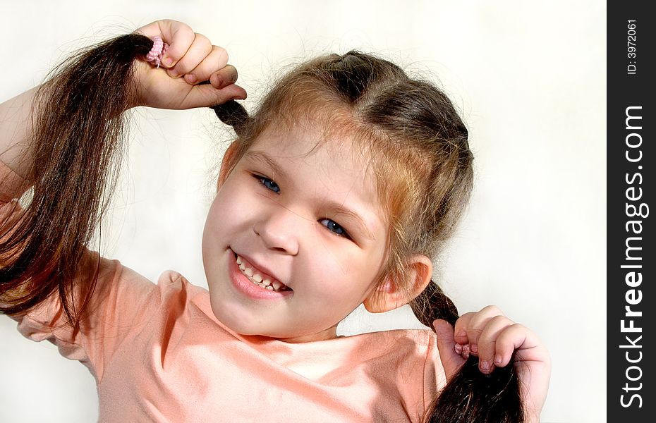 The girl holding her braids, portrait