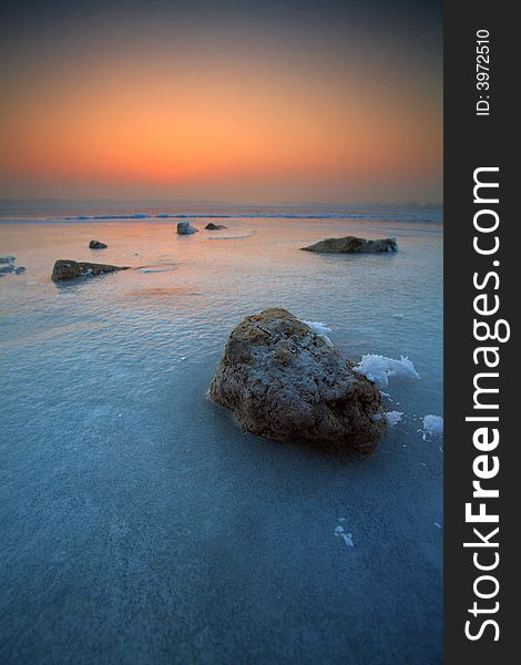 Frozen lake with stones and snow. Frozen lake with stones and snow