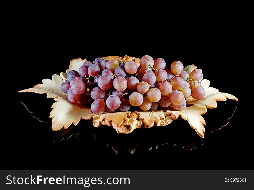 Bowl of red grapes on a black background. Bowl of red grapes on a black background.