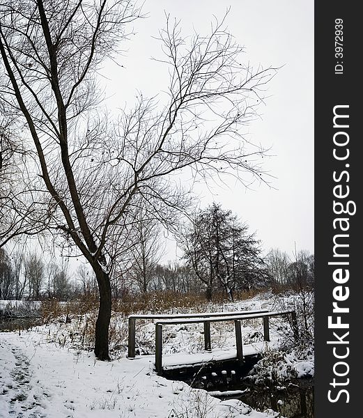 Bridge over river during winter