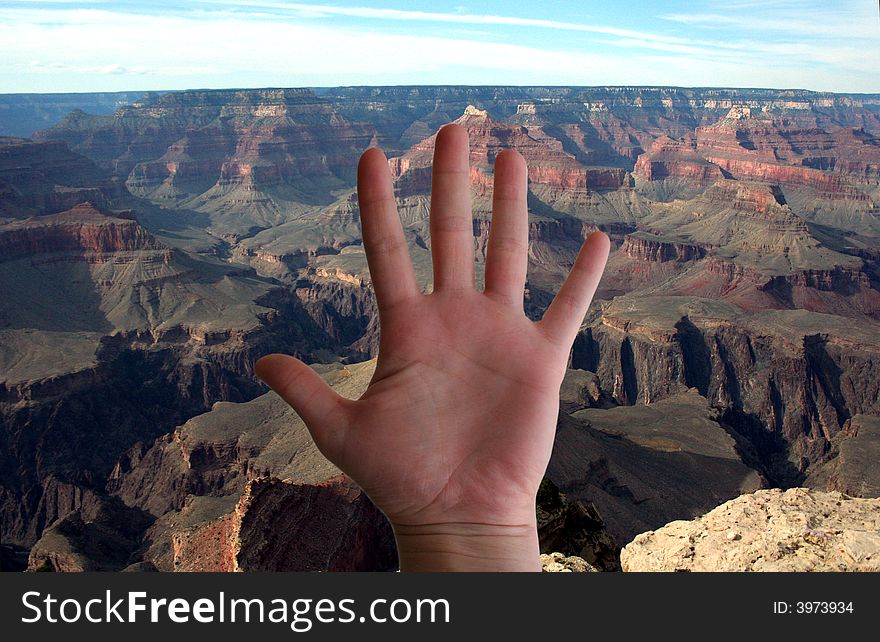 A hand is the center of a Grand Canyon landscape. A hand is the center of a Grand Canyon landscape.