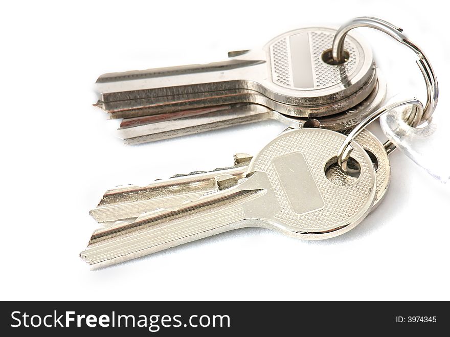 Bunch of old keys on white background