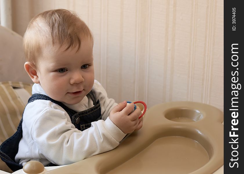 Adorable baby sits at a table