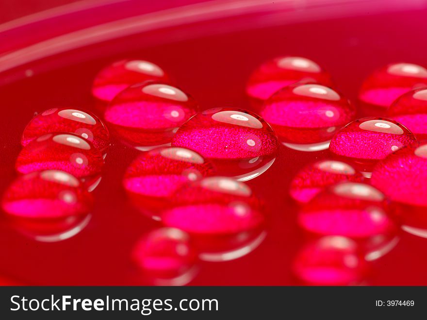 Close up shoot of pink colored water drops. Close up shoot of pink colored water drops