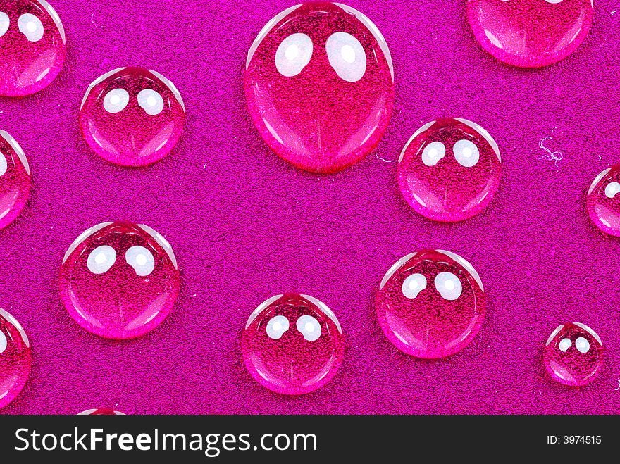 Close up shoot of pink colored water drops. Close up shoot of pink colored water drops