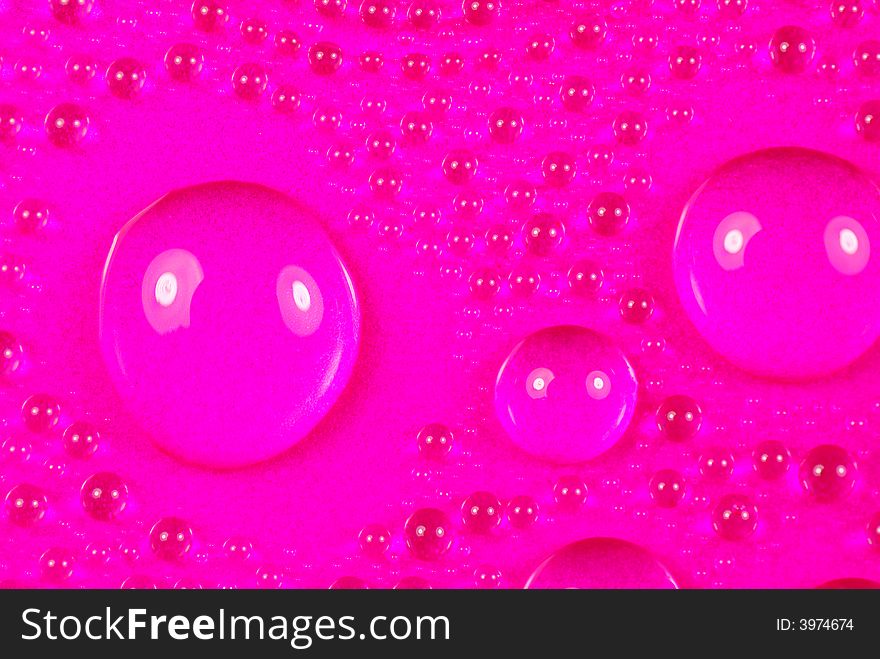 Close up shoot of pink colored water drops. Close up shoot of pink colored water drops