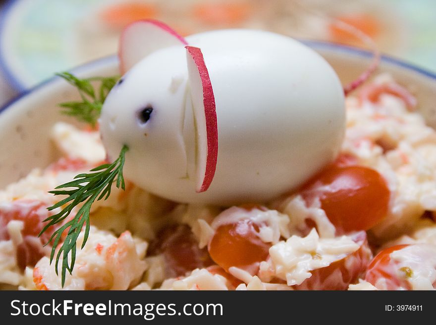 Chinese 2008 New Year symbolic mouse made from egg and radish at the top of served salad