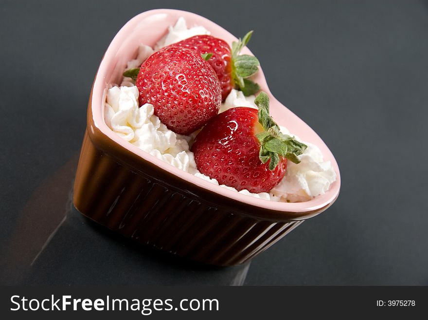 A tasty strawberry dessert isolated on black. A tasty strawberry dessert isolated on black