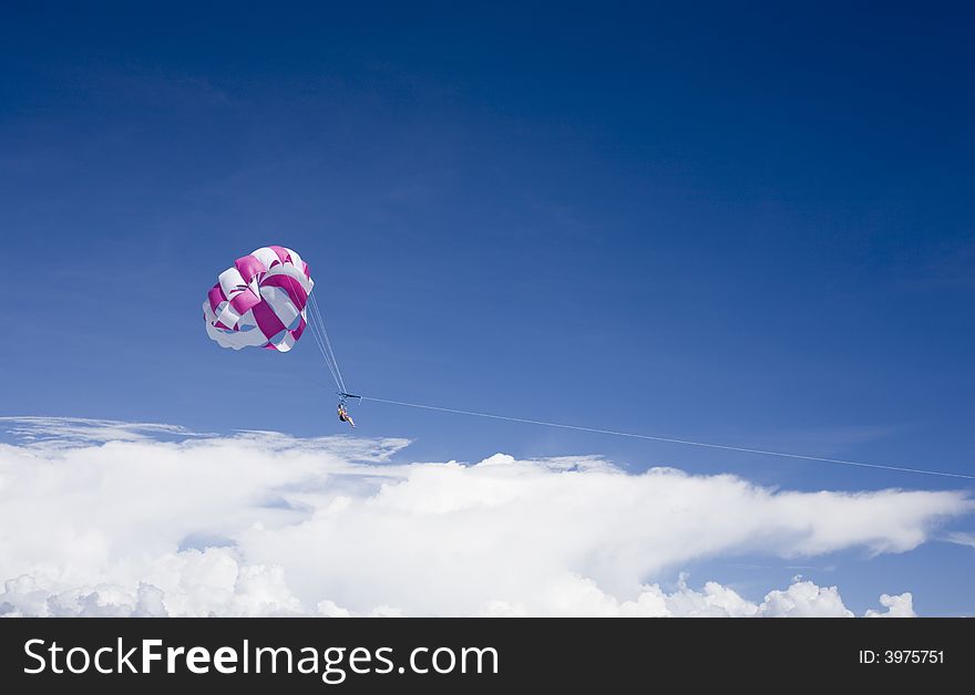 Man is para-sailing and touching the clouds. Man is para-sailing and touching the clouds