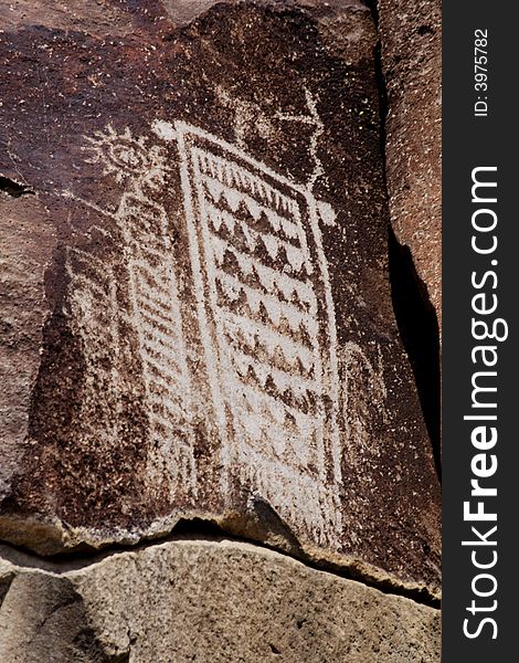 Native American rock art petroglyphs carved into desert varnish covered rock cliffs of Little Petroglyph Canyon of the Coso Range in California. Native American rock art petroglyphs carved into desert varnish covered rock cliffs of Little Petroglyph Canyon of the Coso Range in California