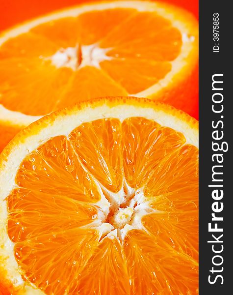 Vertical photo of two sliced orange halves. Vertical photo of two sliced orange halves