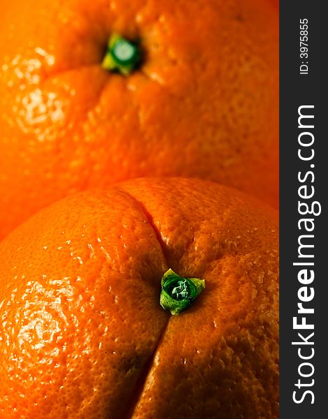 Vertical photo of two whole oranges, each covering half frame. Vertical photo of two whole oranges, each covering half frame