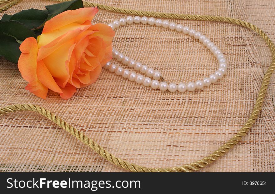 Rose on Textured Background With Pearls and Gold Rope. Rose on Textured Background With Pearls and Gold Rope