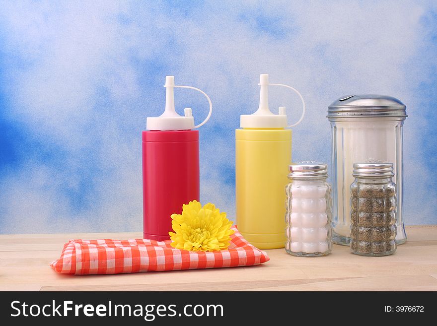 Ketchup, Mustard and Sugar on Blue Textured Background. Ketchup, Mustard and Sugar on Blue Textured Background
