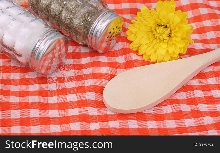 Salt and Pepper Shaker With Flower and Wooden Spoon