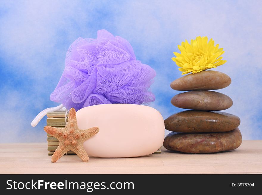 Soap and Massage Stones on Blue Textured Background. Soap and Massage Stones on Blue Textured Background