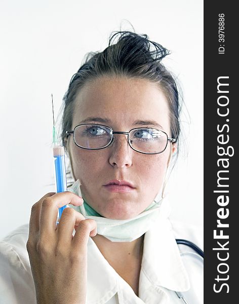 Nurse with glasses holding an injection. Nurse with glasses holding an injection