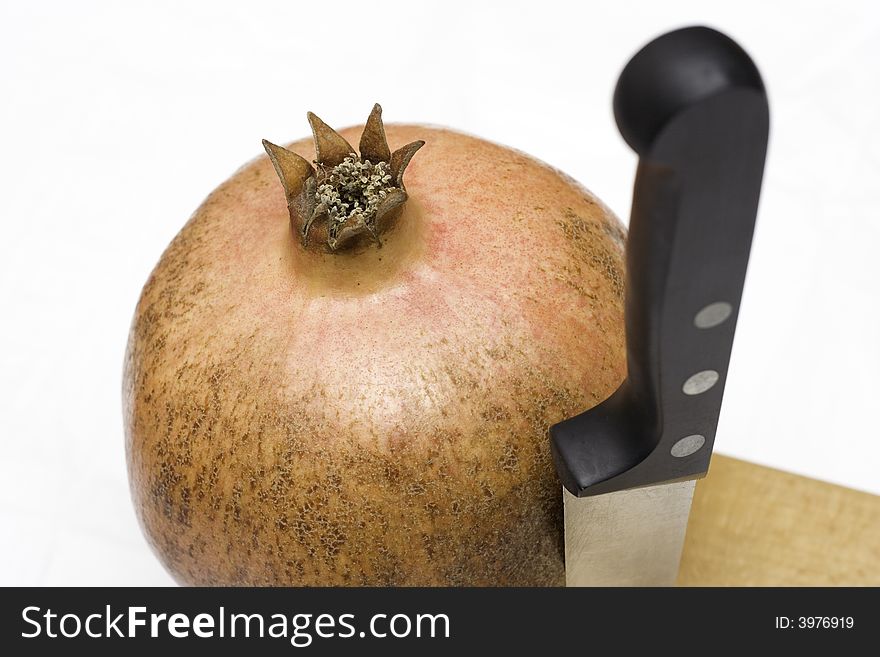 Juicy pomegranate as a dessert and a knife. Juicy pomegranate as a dessert and a knife