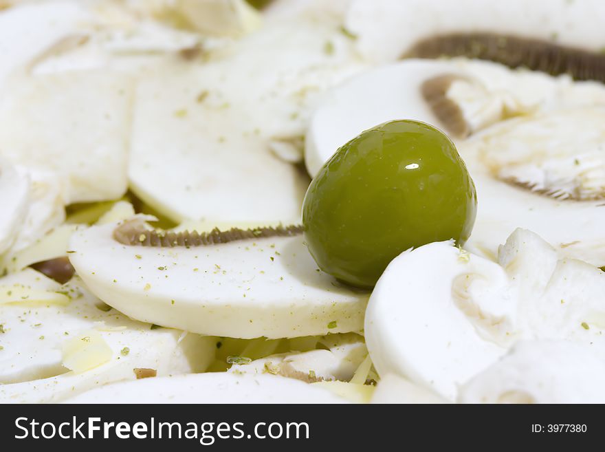 Green olive on white mushroom. Green olive on white mushroom