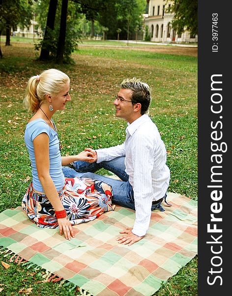 Couple in the park relaxing on the blanket. Couple in the park relaxing on the blanket