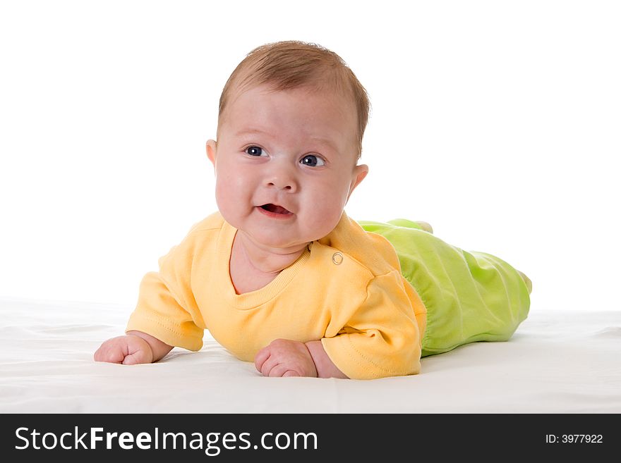 Smiling baby on bed isolated