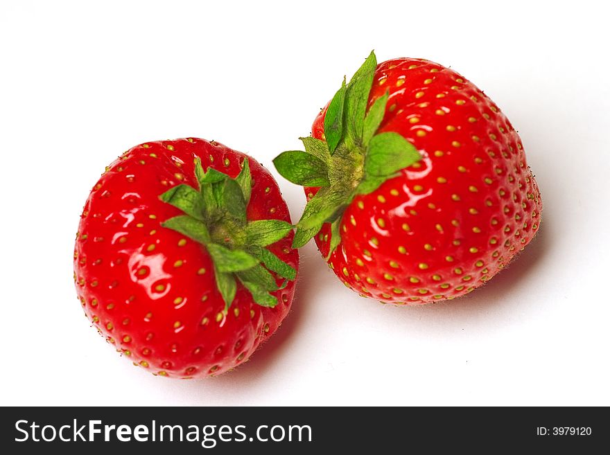 Two appetizing brightly red strawberries on a white background
