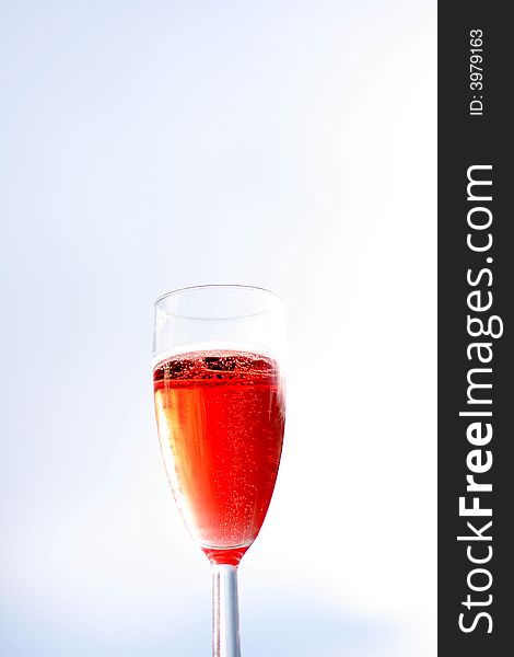 A fresh glass of rose champagne, enjoyed in a beautiful day, midsummer, with clear blue sky and no worries. A fresh glass of rose champagne, enjoyed in a beautiful day, midsummer, with clear blue sky and no worries.