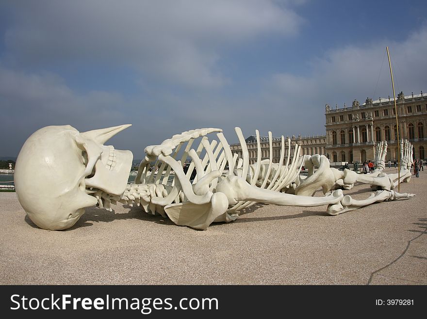 This skeleton is lying in front of the Versailles castle in Paris France. This skeleton is lying in front of the Versailles castle in Paris France.