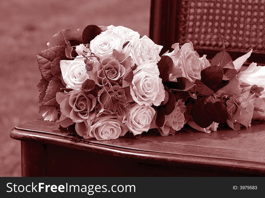 White Wedding bouquet on wooden chair