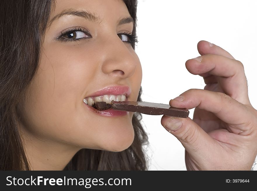 Pretty young woman eating a chocolate. Pretty young woman eating a chocolate