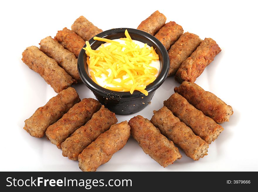 Sausages with a cheese dipping sauce isolated on white