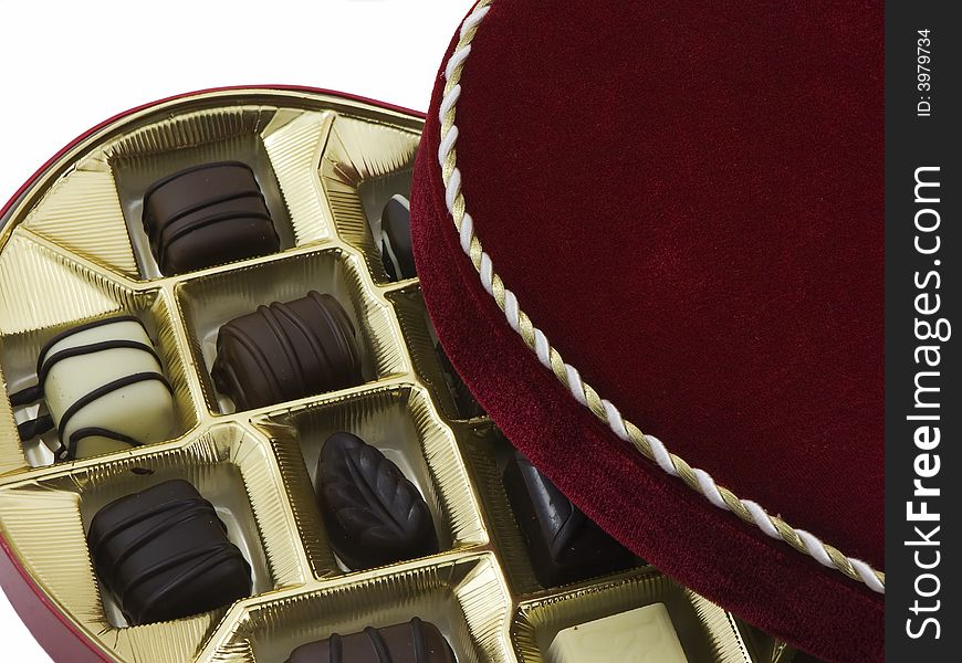 Opened box of valentines chocolates isolated on white