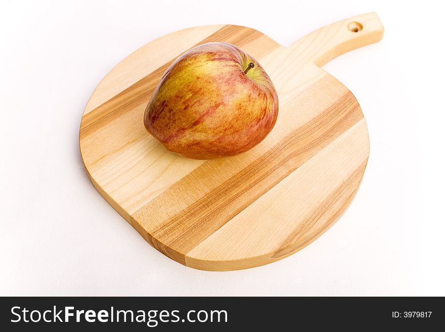 Red apple over a wooden apple shaped potstand