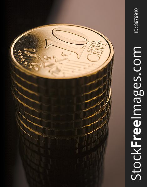 10 euro cent coins stacked on black table