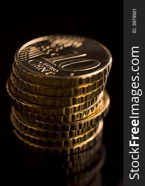 10 euro cent coins stacked on black table