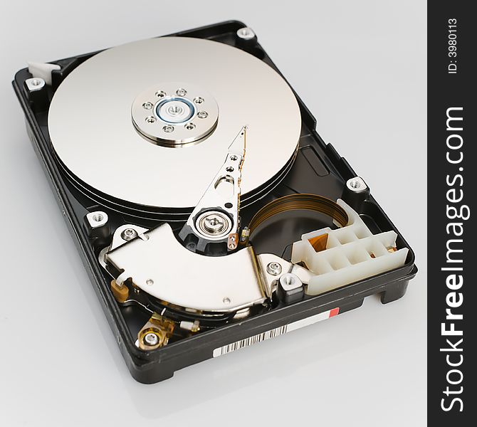 Modern opened hard disk drive over a white surface